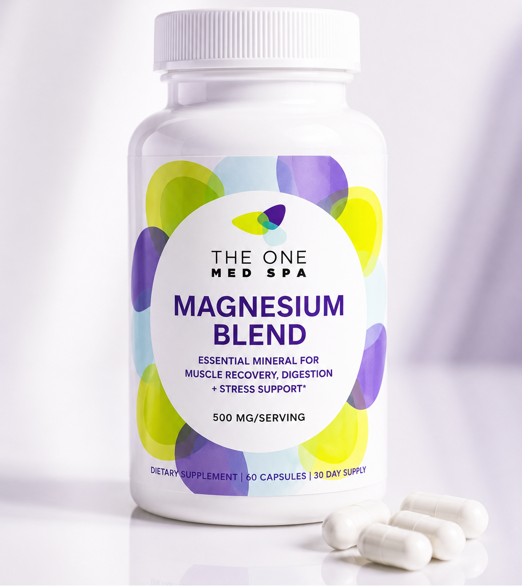 A white bottle of The One Med Spa Magnesium Blend dietary supplement with a white cap, shown on a clean white background with several white capsules placed in front of the bottle.