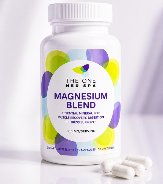 A white bottle of The One Med Spa Magnesium Blend dietary supplement with a white cap, shown on a clean white background with several white capsules placed in front of the bottle.